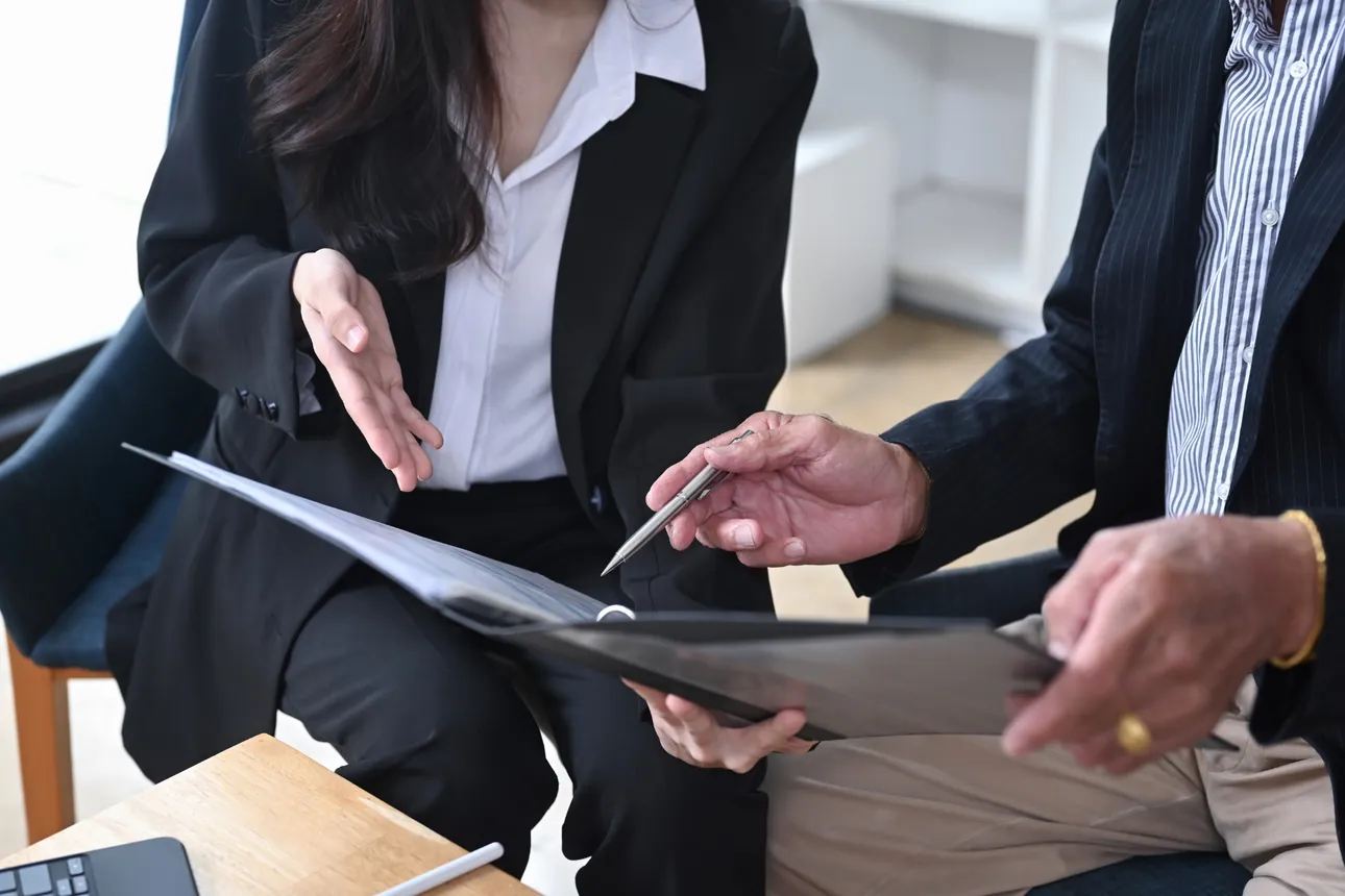 Advisor and client reviewing documents in a folder