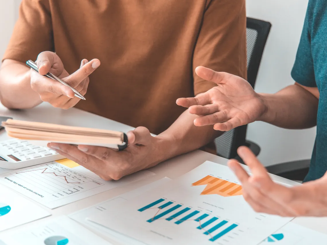 Risk management advisors discussing financial charts